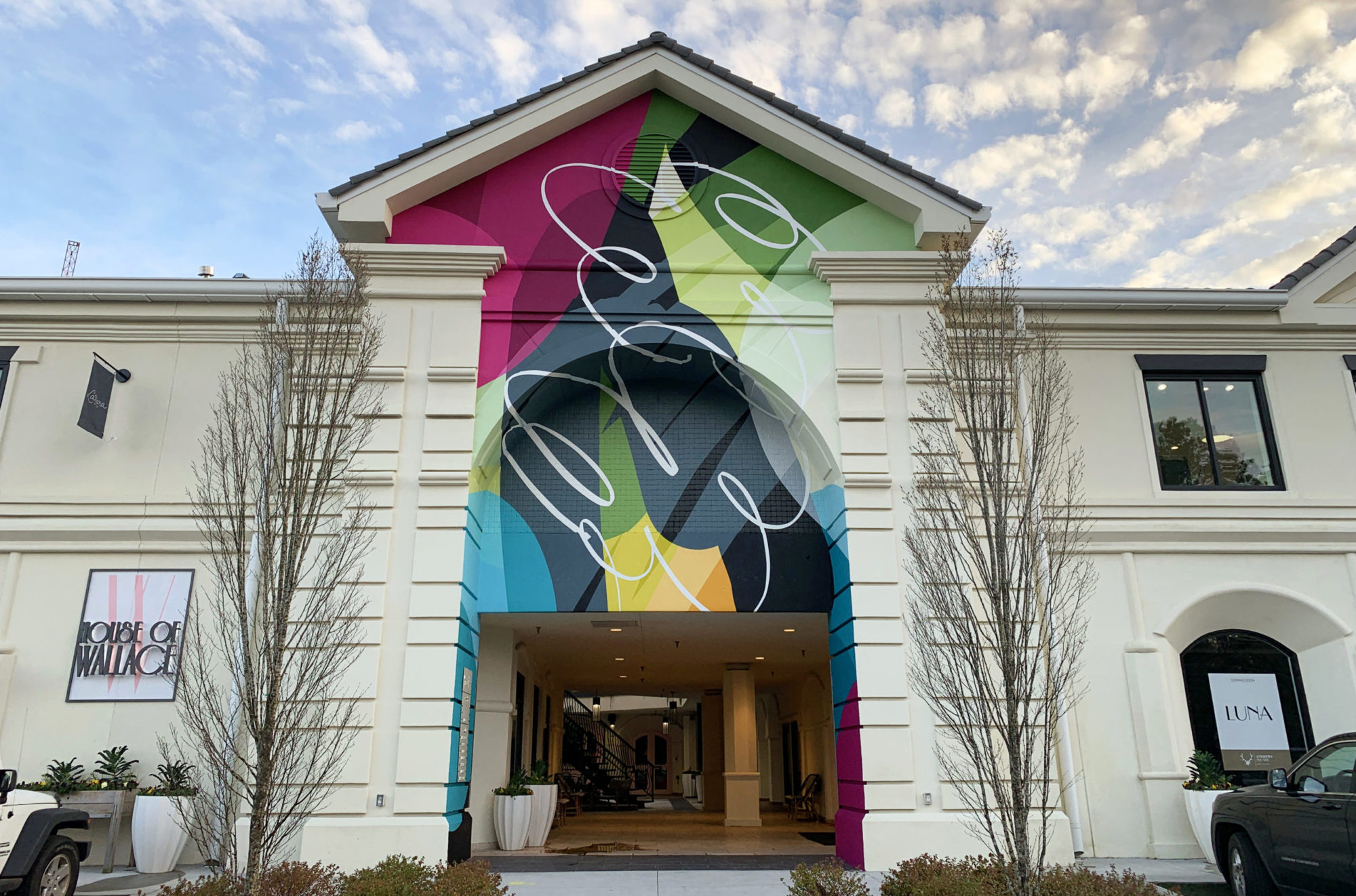 Colorful mural on building in buckhead shopping plaza by Ryan Coleman