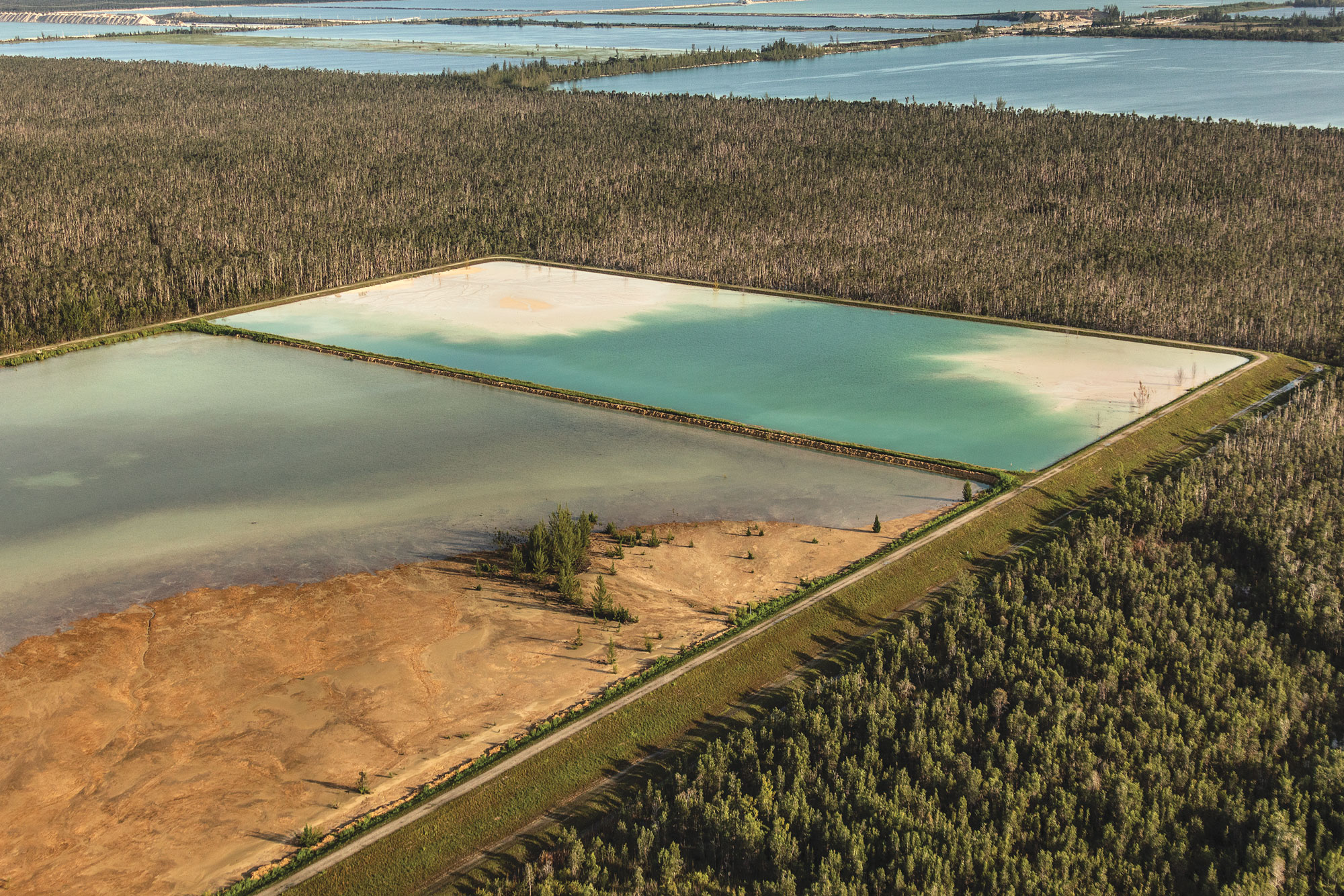 Birds eye photograph of a rectangular body of water and landscape.