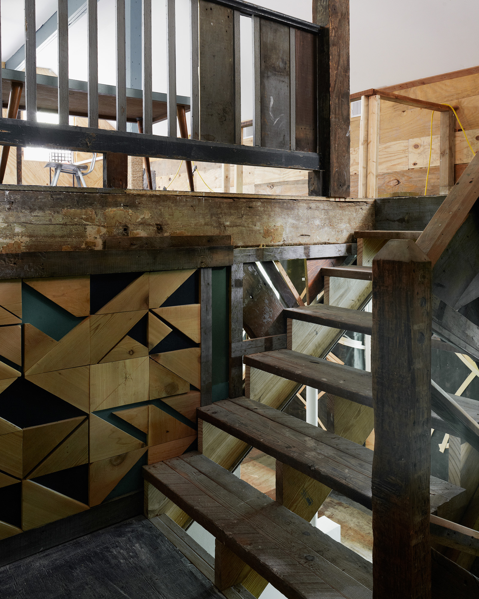 Interior of Theaster Gates' house in Hyde Park; Shot from wooden staircase landing up into a loft area