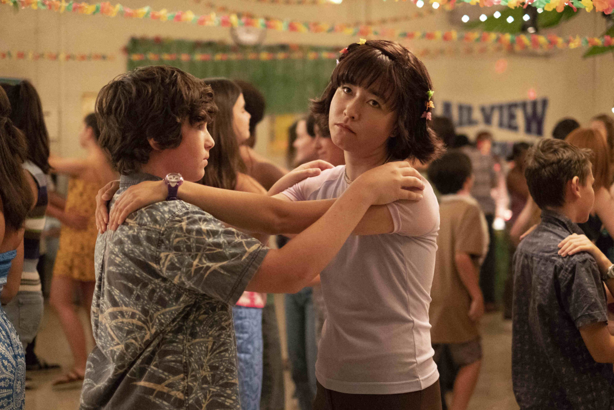 Actress Maya Erskine at a middle school dance in a scene from TV show 