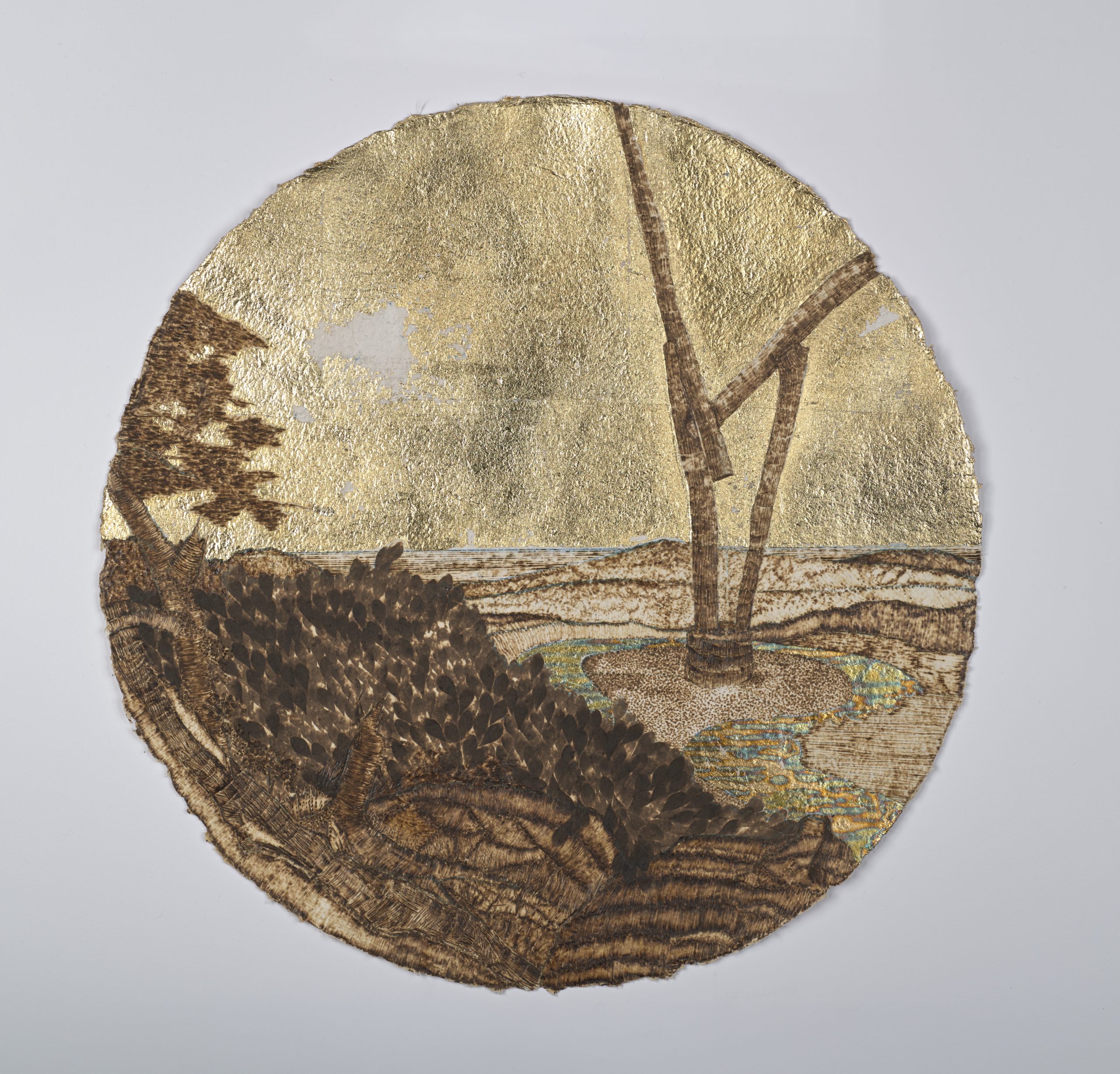 Circular piece of paper depicting trees, a river, and a horizon