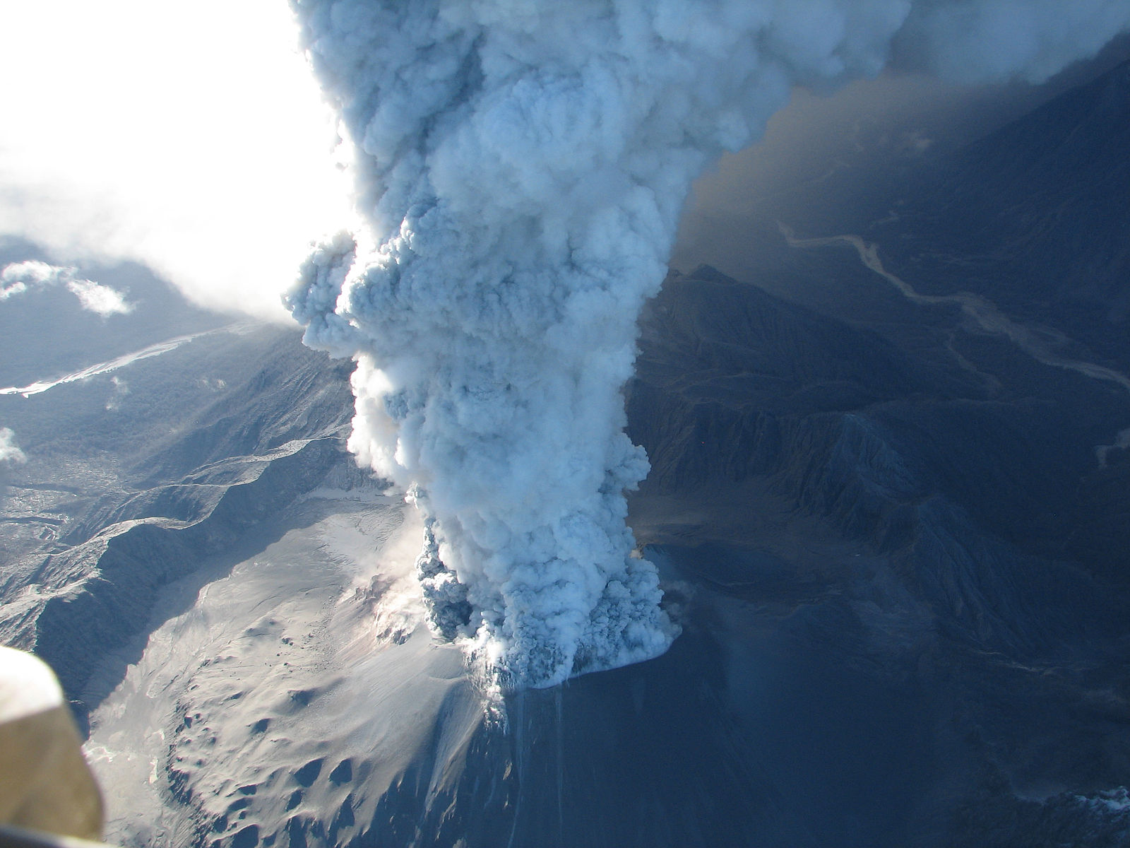 An aerial image of columns of smoke emerging from a volcano.