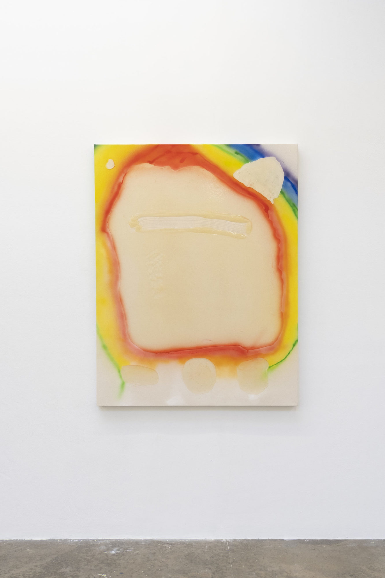 An abstract, acrylic painting, which incorporates beige and primary colors, hangs from a white wall