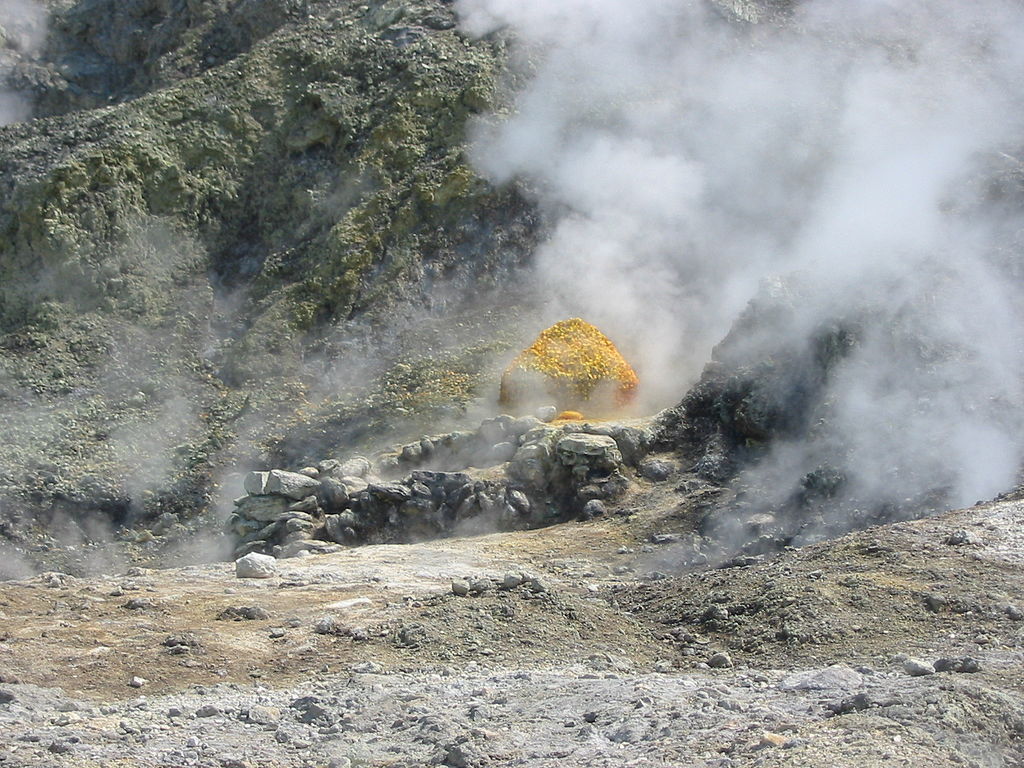 A ground level view of campi flegrei. Steam is coming up from the rocks.