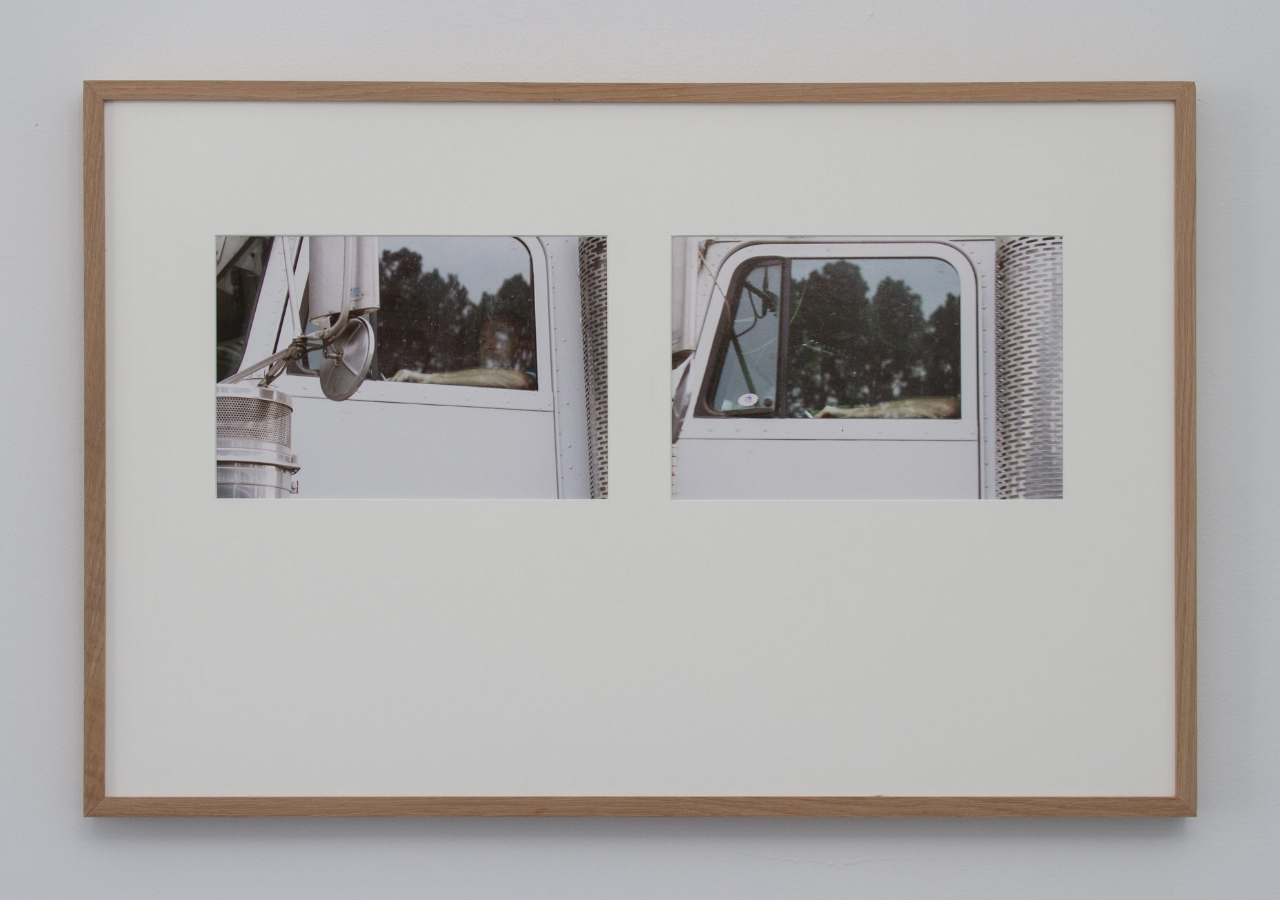 Two images of the same truck window side by side in a frame. The photo on the left is angled upwards towards the window while the photo on the left is straight on.