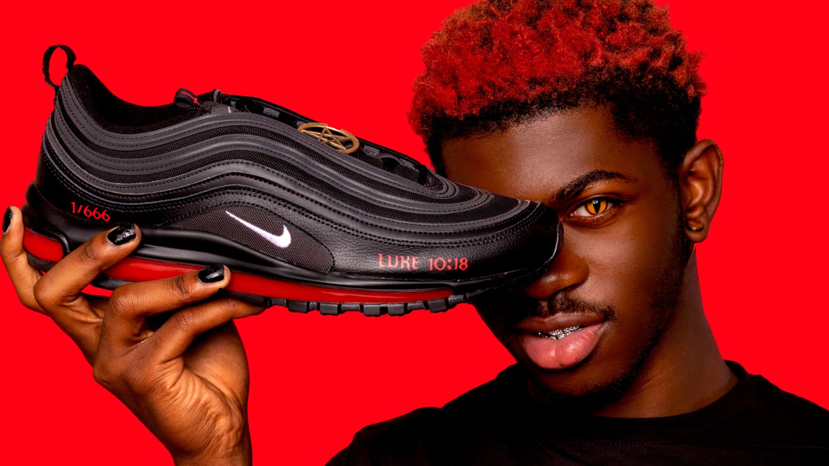 This a photo of Lil Nas X with his Black and Red Satan Shoes.
