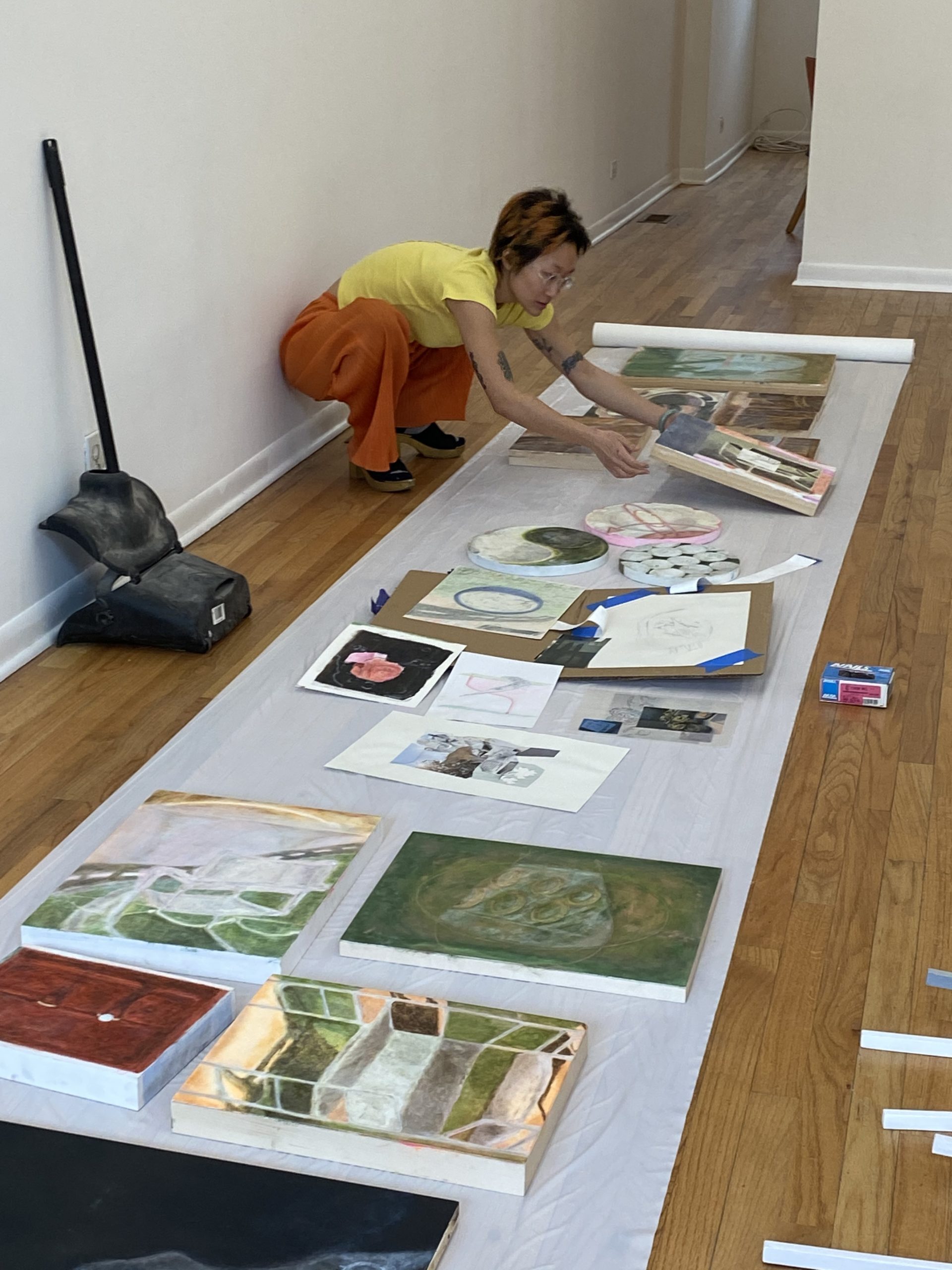 This is a photo of Angela Zhang preparing some of her art work.