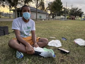 The artist Malcolm Peacock sitting in a New Orleans park as part of the performance for We Served...