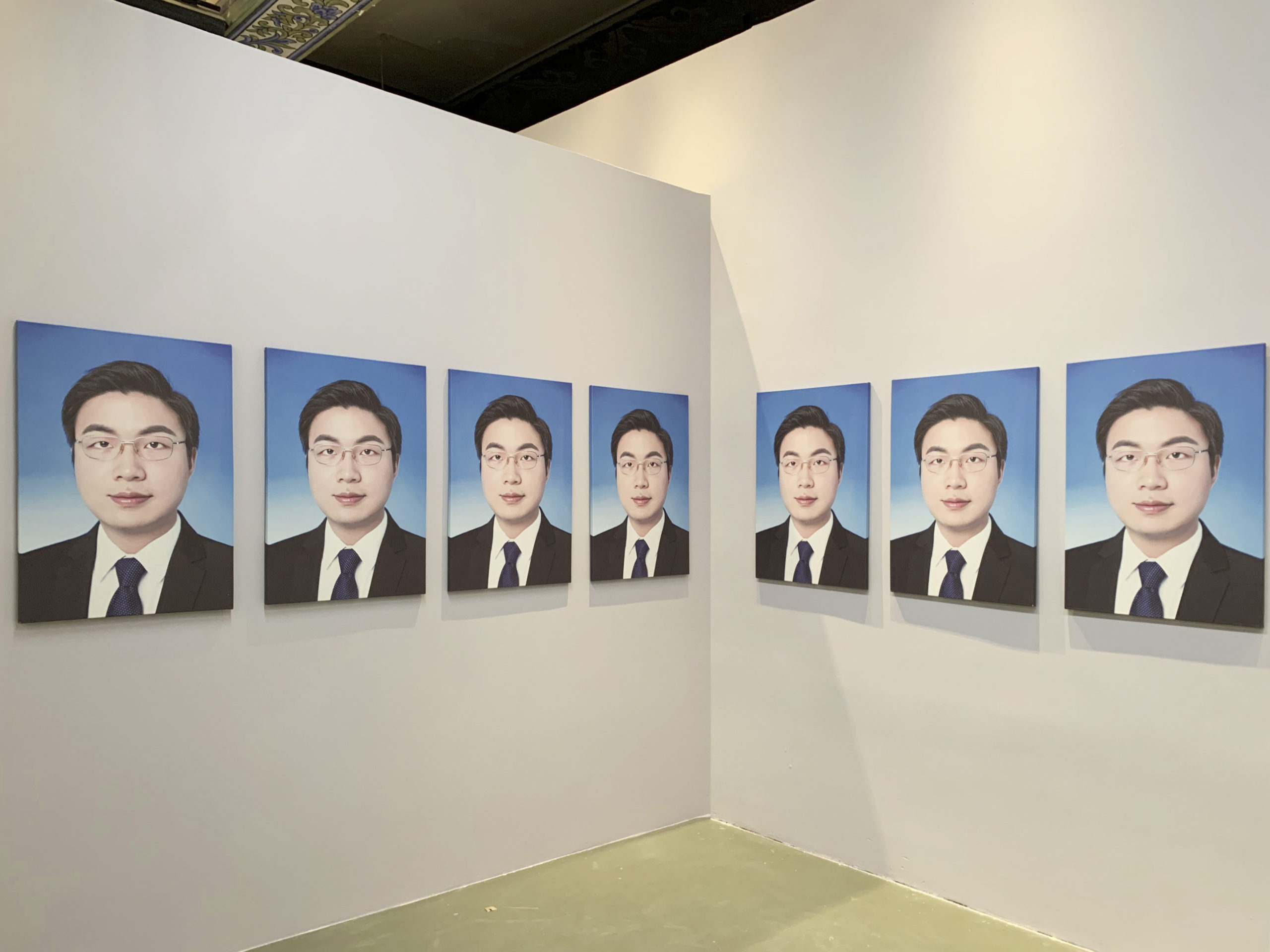 A row of self-portraits the artist, Ge Yulu has made in the style of government officials.