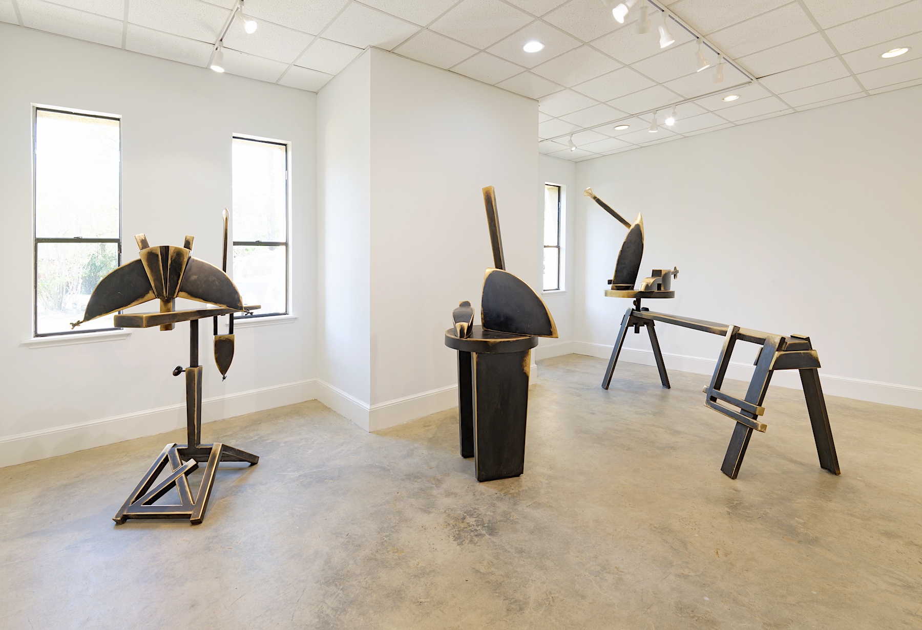 A view of the gallery installed with Curts Patterson's bronze sculptures filling a large bright white room.