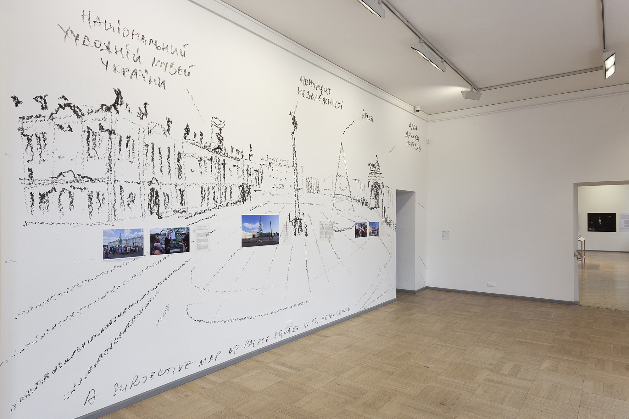 A white wall with a black drawing of it depicting Palace Square