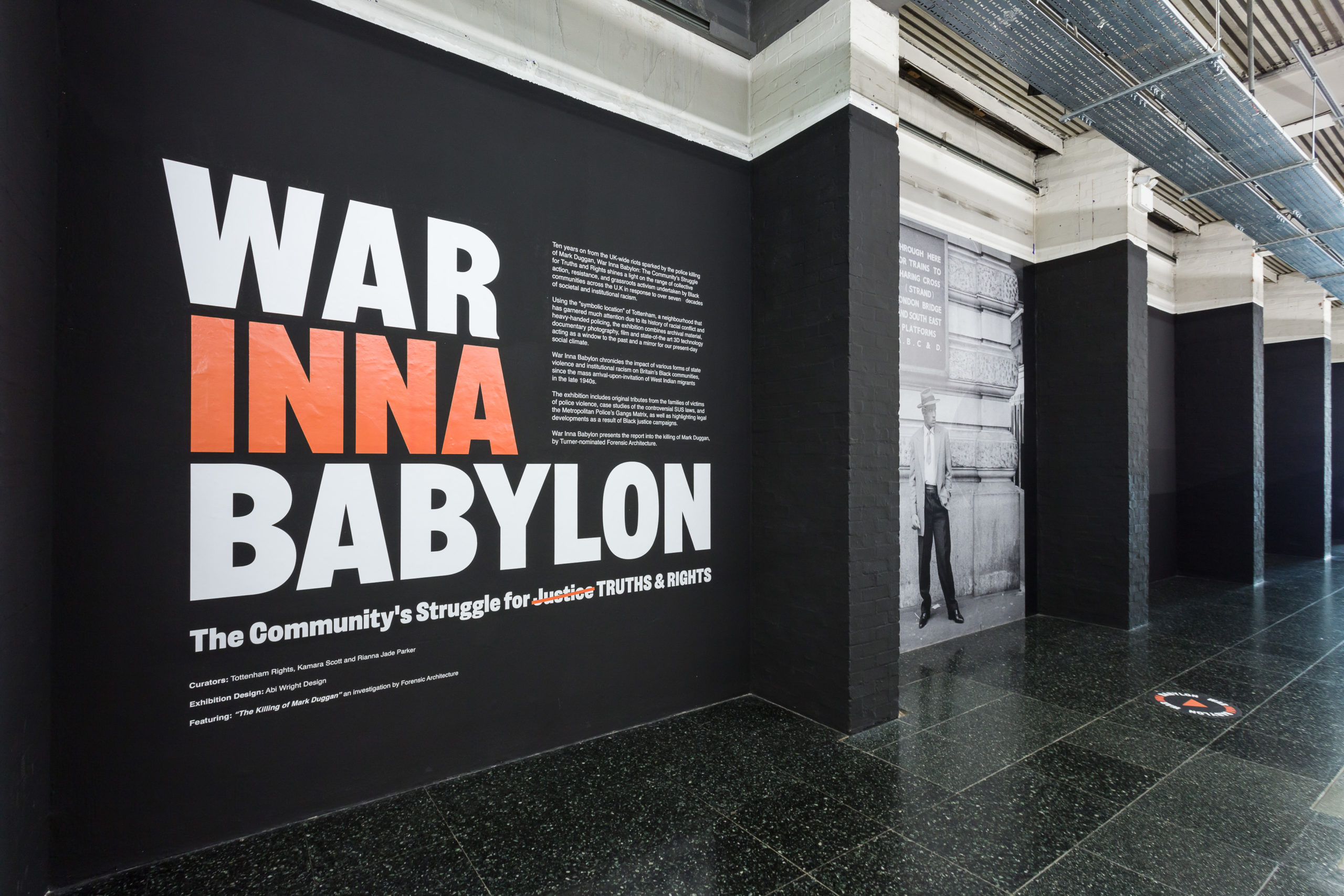 A black wall with the title of the exhibition.