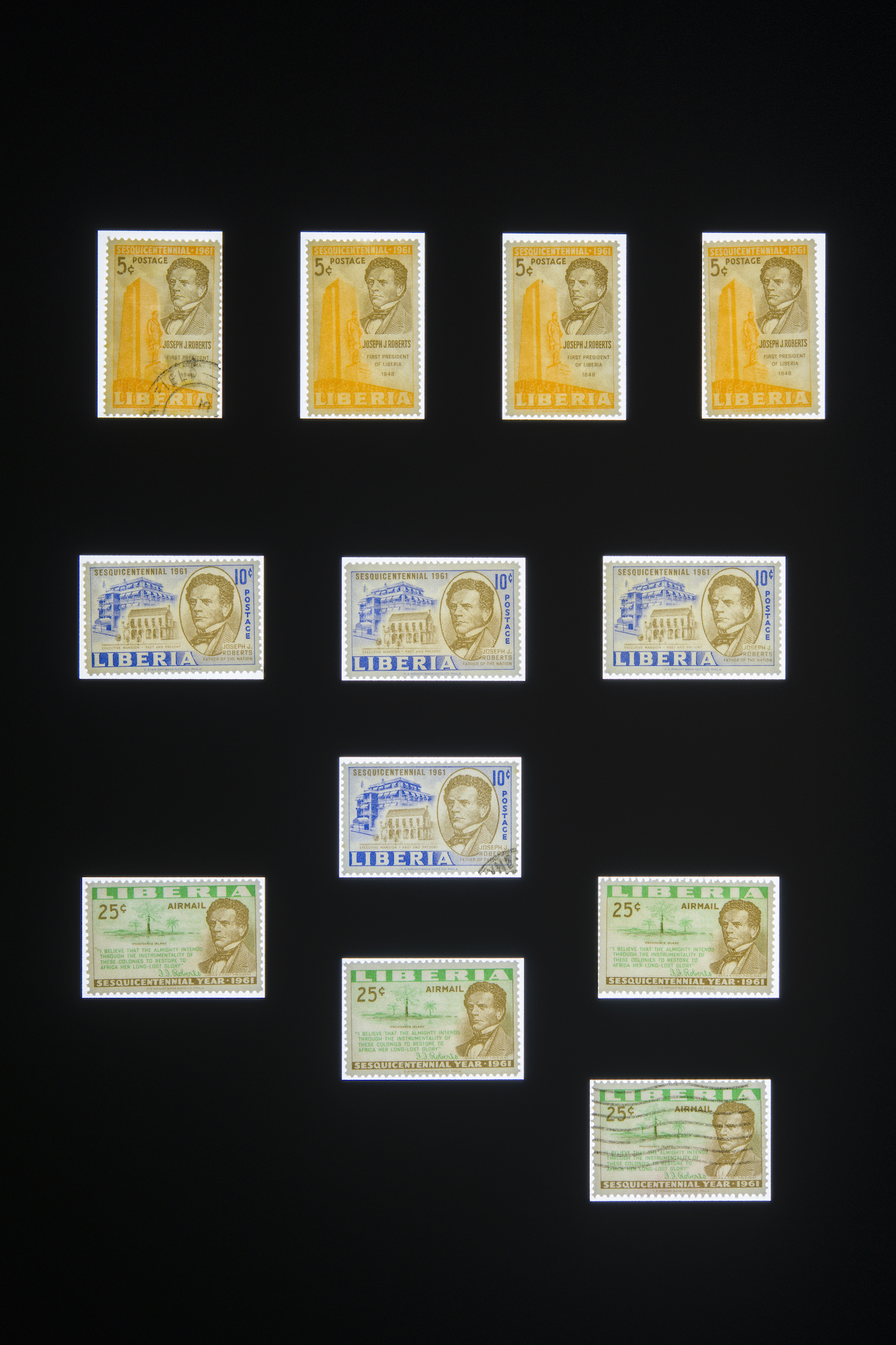 A series of stamps float amidst a black background with variations of color from yellow, to blue, to green and reading 