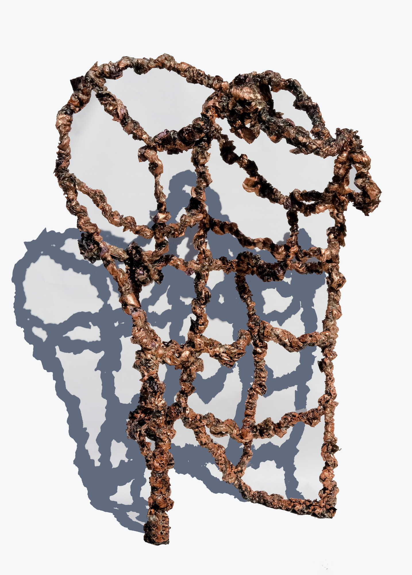 A rust colored structure rendered of steel and fabric standing upright and curved atop casting a stark shadow against a white backdrop