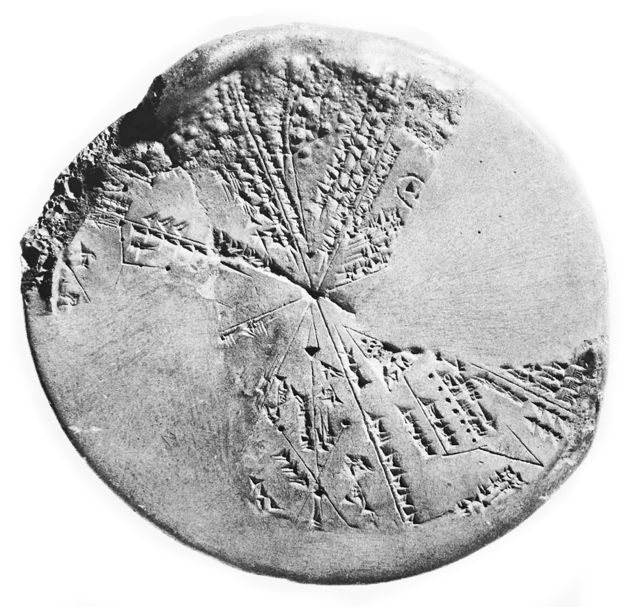Flat, light grey, circular rock with partial ancient etchings.